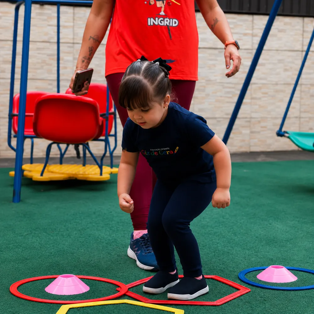 Criança em circuito de psicomotricidade no pátio da escola